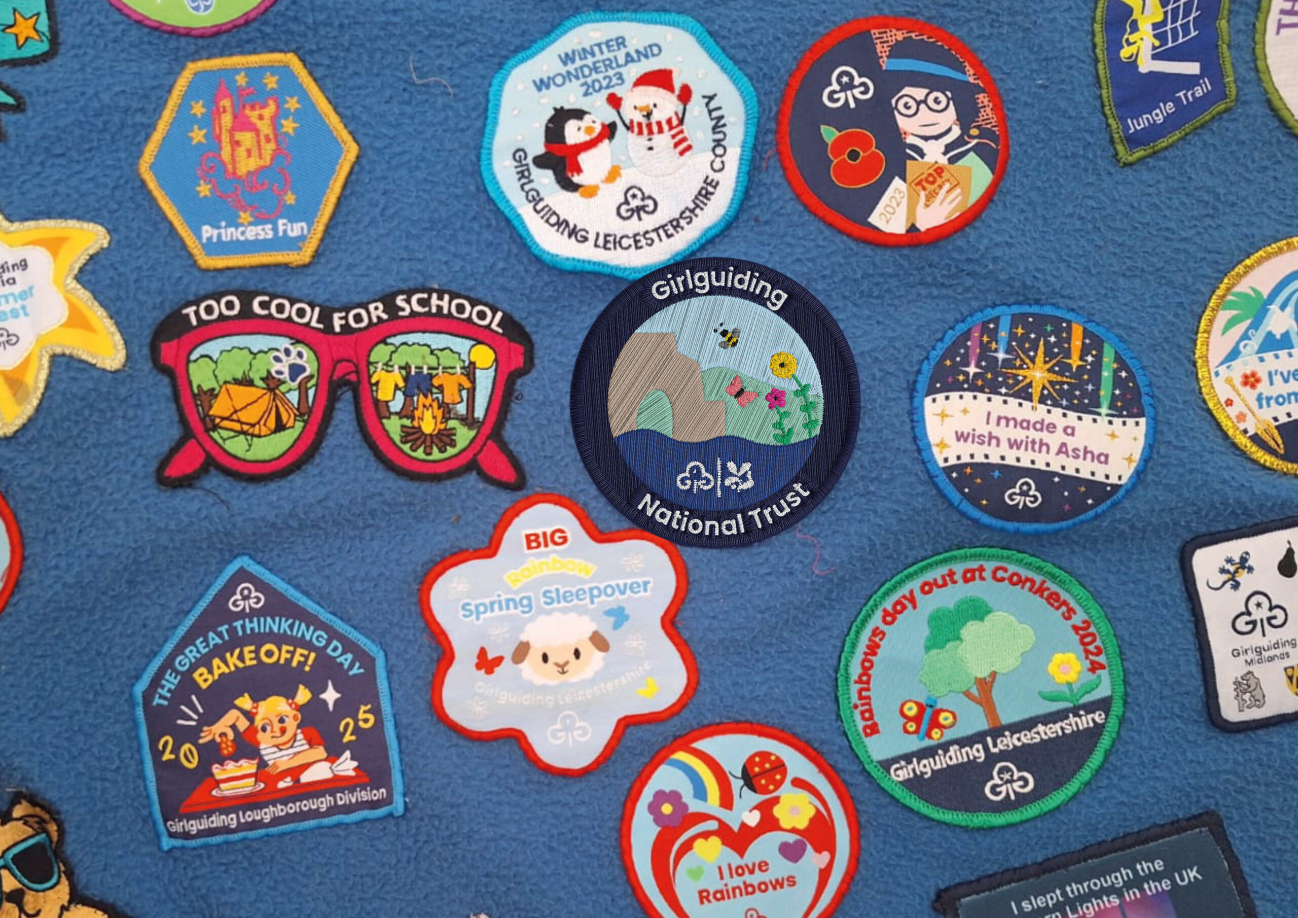 A Girlguiding camp blanket that has the new badge design on it