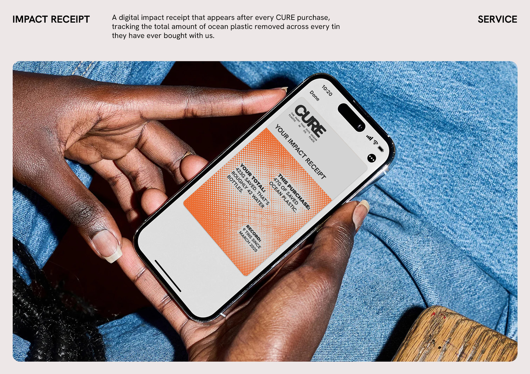 A hand holding a phone displaying a CURE digital impact receipt.
