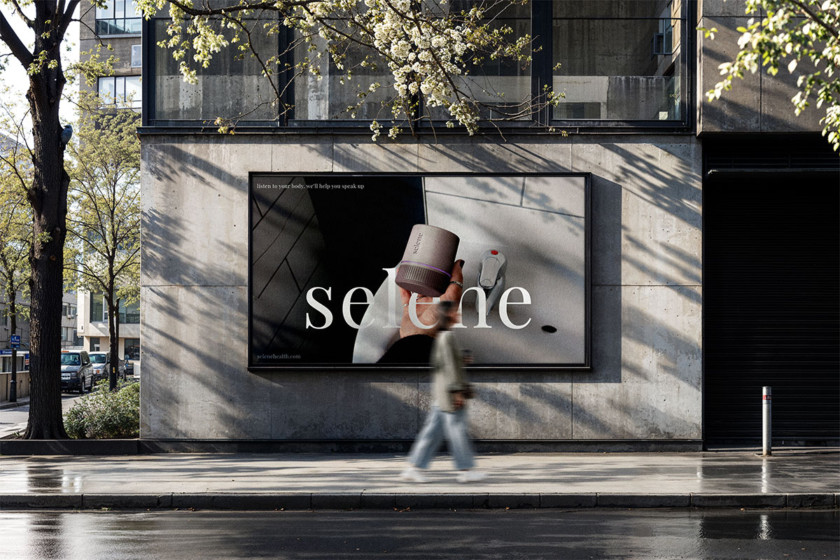 an advertisement of the selene device being held, with the text "selene" being written across